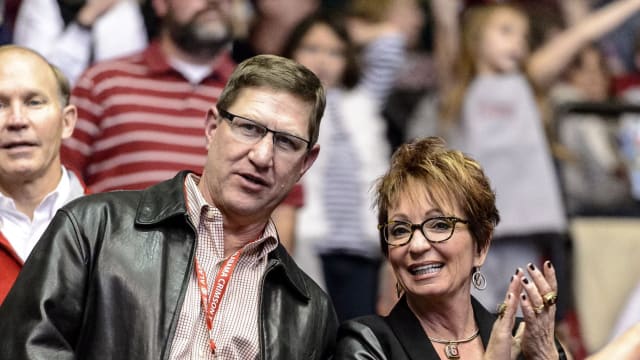 Sarah and David Patterson cheering on a gymnastics meet post-retirement