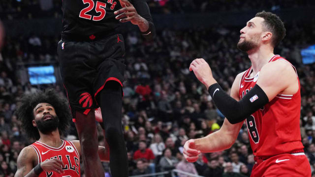 Toronto Raptors forward Chris Boucher (25) scores a basket over Chicago Bulls guard Zach LaVine (8) during the second quarter at Scotiabank Arena