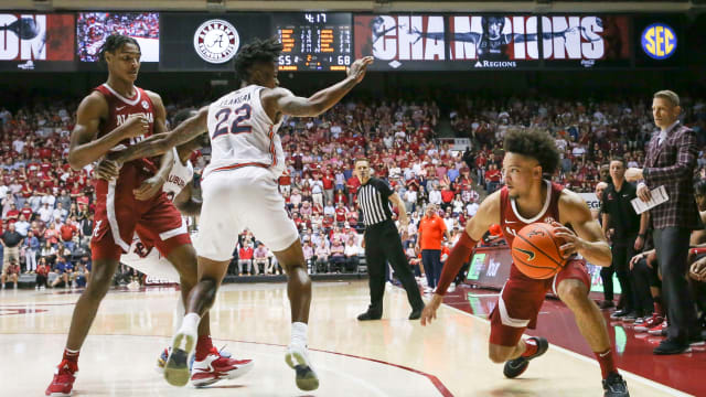 Alabama guard Mark Sears (1) maneuvers with the ball as Auburn guard Allen Flanigan (22) attempts to guard him at Coleman Coliseum. Alabama defeated Auburn 90-85 in overtime 