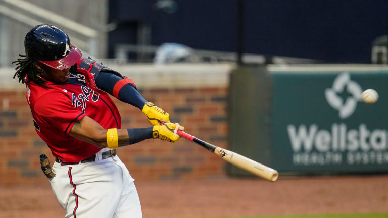 Atlanta Braves outfielder Ronald Acuña Jr. confronted by two fans