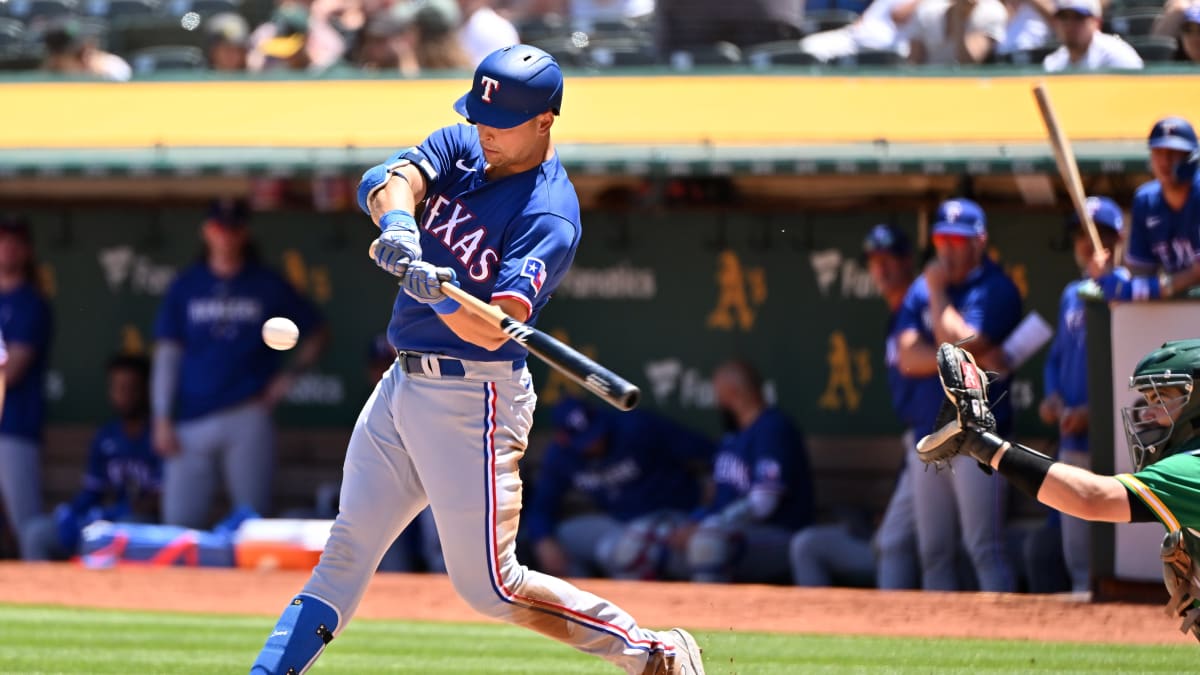 Nathaniel Lowe of the Texas Rangers points to the dugout during the News  Photo - Getty Images