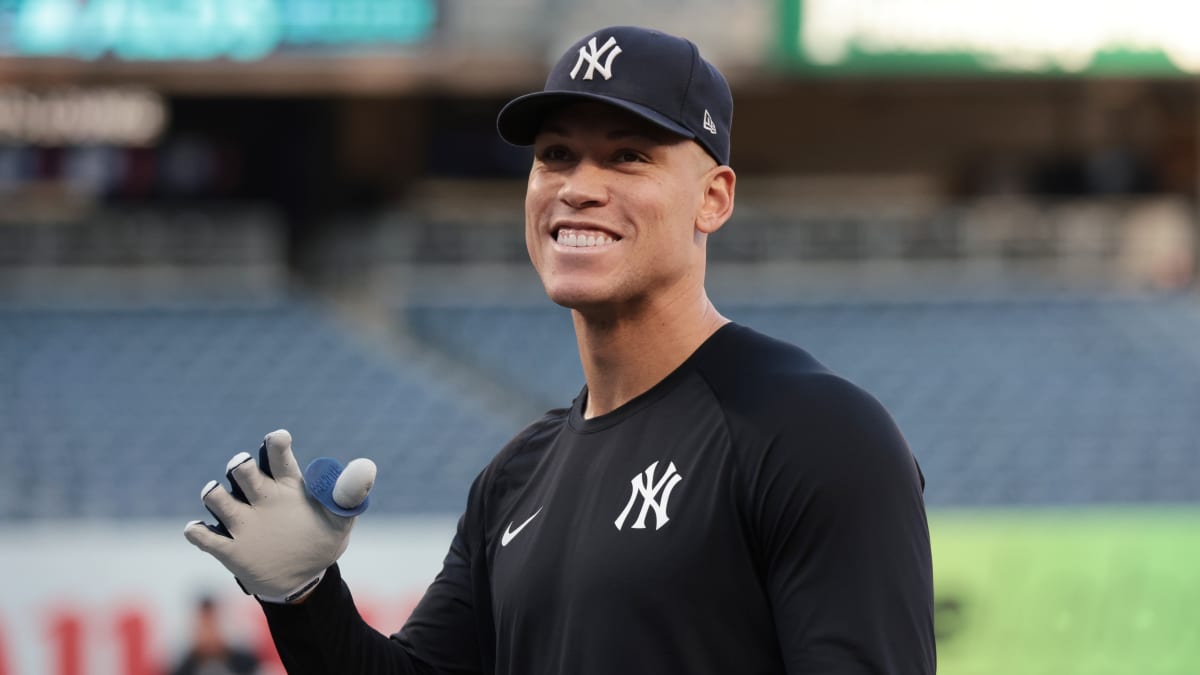 New York Yankees' Aaron Judge, left, warms up wearing the number