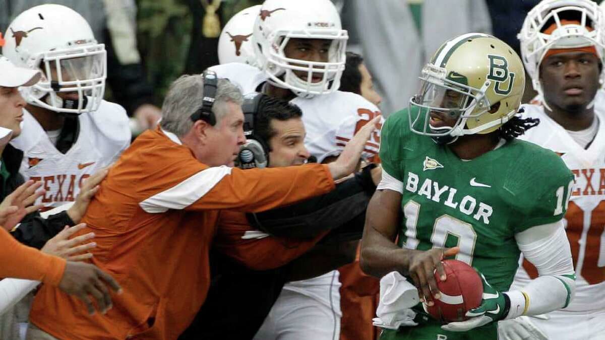 Baylor quarterback Robert Griffin III stands on the stage holding