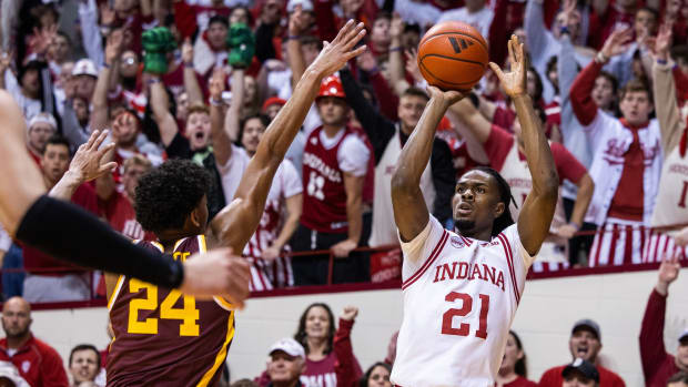 Indiana Hoosiers forward Mackenzie Mgbako (21) shoots the ball while Minnesota Golden Gophers guard Cam Christie (24) defends in the first half at Simon Skjodt Assembly Hall.