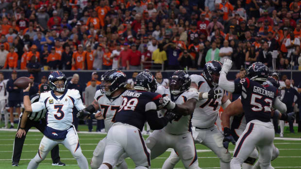 Broncos quarterback Russell Wilson drops back in the pocket against the Houston Texans in the second half at NRG Stadium.