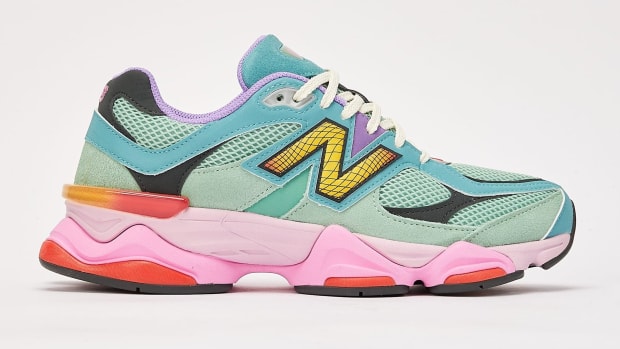 Side view of green and pink New Balance shoe.