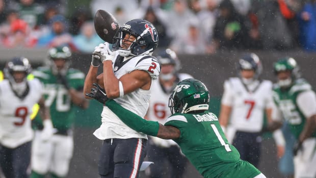 Dec 10, 2023; East Rutherford, New Jersey, USA; New York Jets cornerback Sauce Gardner (1) breaks up a pass intended for Houston Texans wide receiver Robert Woods (2) during the first half at MetLife Stadium. Mandatory Credit: Vincent Carchietta-USA TODAY Sports