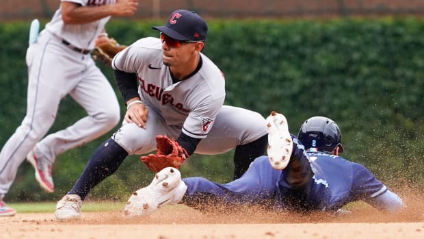 Jun 30, 2023; Chicago, Illinois, USA; Chicago Cubs second baseman Nico Hoerner (2) steals second base as Cleveland Guardians second baseman Andres Gimenez (0) makes a late tag during the fourth inning at Wrigley Field. Mandatory Credit: David Banks-USA TODAY Sports