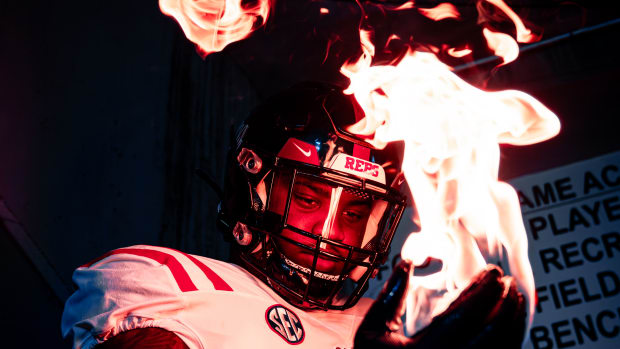 Ole Miss defensive lineman J.J. Pegues models the Rebels' uniform choice as they prepare to take on his former team on Saturday night.