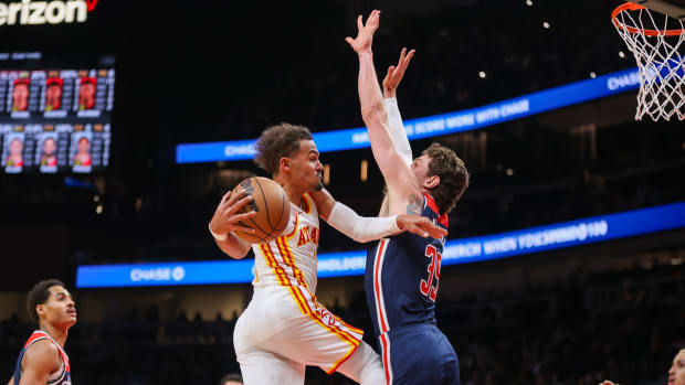 Atlanta Hawks guard Trae Young (11) passes the ball around Washington Wizards center Mike Muscala (35) in the second quarter at State Farm Arena.