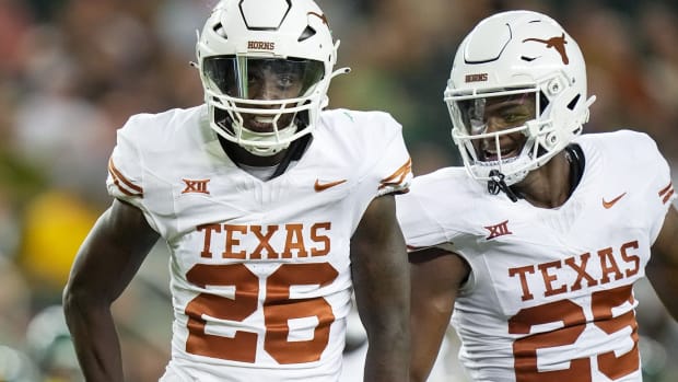 Texas running back Quintrevion Wisner (26) and Texas defensive back Jelani McDonald (25) celebrates a big tackle on the kick return in the third quarter of an NCAA college football game. 