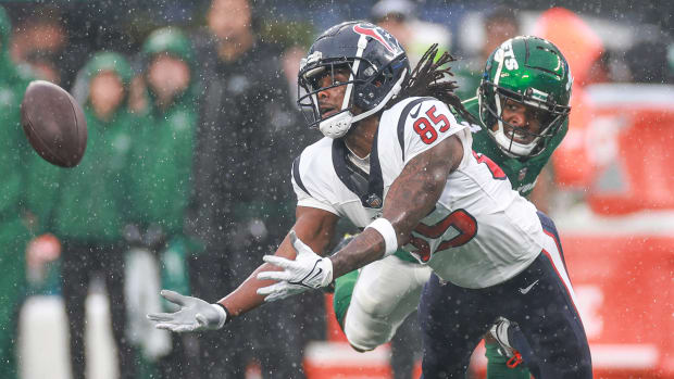 Dec 10, 2023; East Rutherford, New Jersey, USA; Houston Texans wide receiver Noah Brown (85) reaches for a pass during the first half in front of New York Jets cornerback D.J. Reed (4) at MetLife Stadium. Mandatory Credit: Vincent Carchietta-USA TODAY Sports