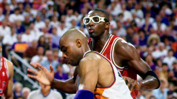 Jun 1993; Phoenix, AZ, USA; FILE PHOTO; Phoenix Suns forward Charles Barkley (34) is defended by Chicago Bulls forward Horace Grant (back) during the 1993 NBA Finals at America West Arena.