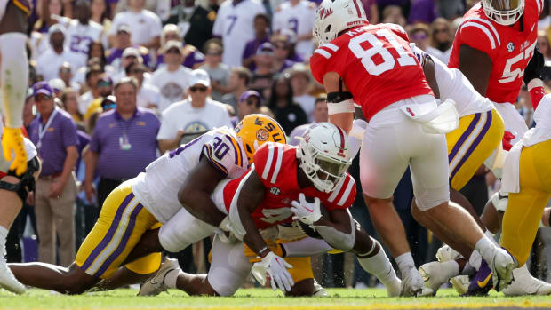 Oct 22, 2022; Baton Rouge, Louisiana, USA; Mississippi Rebels running back Quinshon Judkins (4) rushes in for a touchdown against LSU Tigers linebacker Greg Penn III (30) during the first half at Tiger Stadium. Mandatory Credit: Stephen Lew-USA TODAY Sports