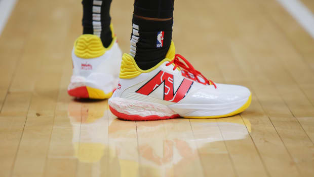 Atlanta Hawks guard Dejounte Murray's white, red, and yellow New Balance sneakers.