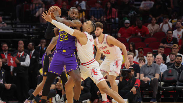 Lakers forward LeBron James (23) defends the ball from Houston Rockets forward Dillon Brooks (9) in the first quarter at Toyota Center.