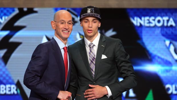 Jun 26, 2014; Brooklyn, NY, USA; Zach LaVine shakes hands with NBA commissioner Adam Silver after being selected as the number thirteen overall pick to the Minnesota Timberwolves in the 2014 NBA Draft at the Barclays Center.