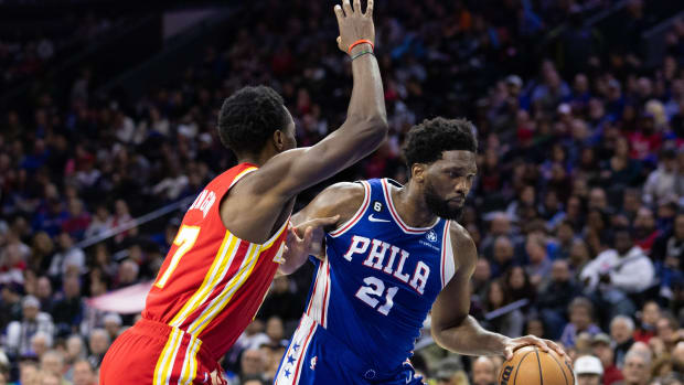 76ers center Joel Embiid dribbles past Hawks forward Onyeka Okongwu.