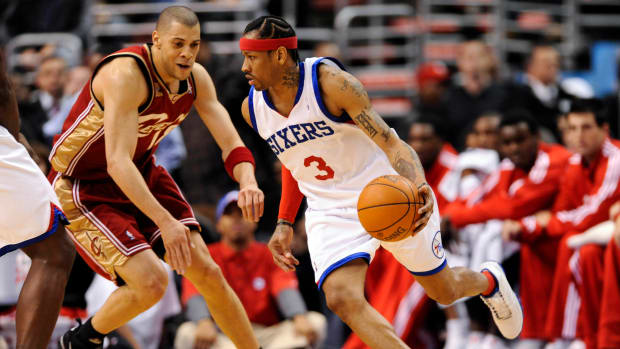 Philadelphia 76ers guard Allen Iverson dribbles by Cleveland Cavaliers guard Anthony Parker.