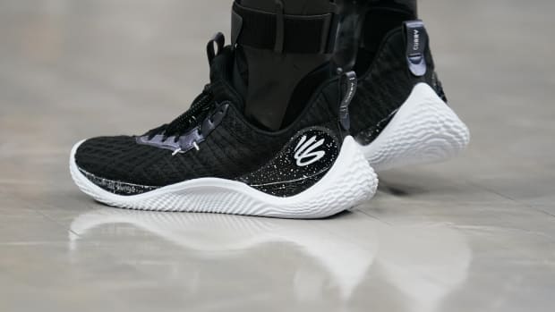 View of black and white Curry shoes.