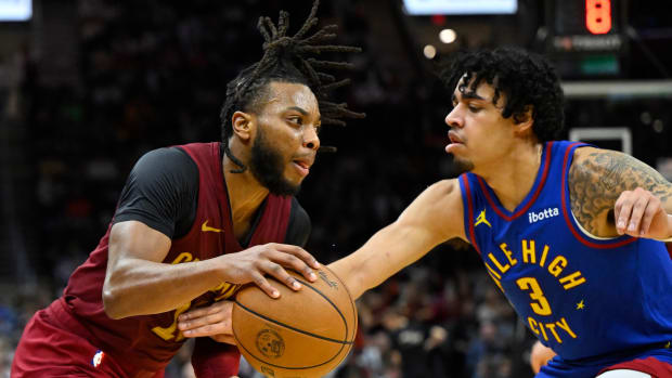 Nov 19, 2023; Cleveland, Ohio, USA; Cleveland Cavaliers guard Darius Garland (10) drives against Denver Nuggets guard Julian Strawther (3) in the fourth quarter at Rocket Mortgage FieldHouse.