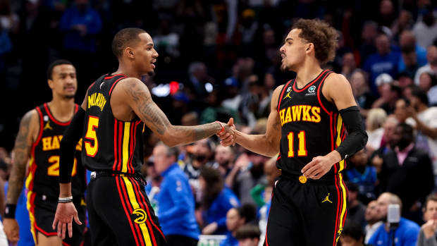 Atlanta Hawks guards Dejounte Murray and Trae Young celebrate after a play.