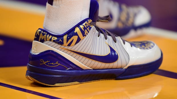 View of white, purple, and gold Kobe shoes.