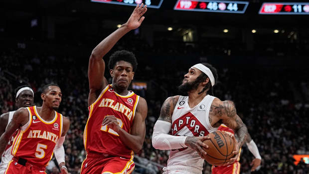 Raptors guard Gary Trent Jr. dribbles to the rim against Hawks forward De'Andre Hunter.