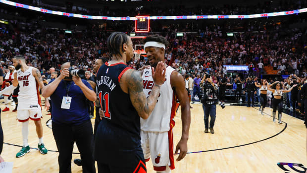 Apr 14, 2023; Miami, Florida, USA; Miami Heat forward Jimmy Butler (22) talks to Chicago Bulls forward DeMar DeRozan (11) after the game at Kaseya Center.