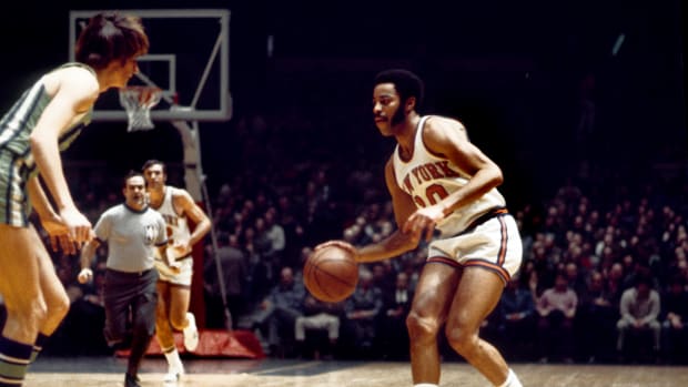 New York Knicks guard Walt Frazier dribbles the ball against the Atlanta Hawks defense.