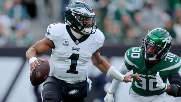 Philadelphia Eagles quarterback Jalen Hurts (1) drops back to pass against New York Jets cornerback Michael Carter II (30) during the first quarter at MetLife Stadium.