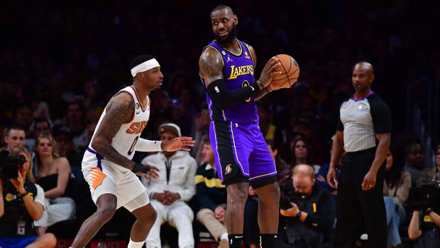 Apr 7, 2023; Los Angeles, California, USA; Los Angeles Lakers forward LeBron James (6) moves the ball against former Phoenix Suns forward Torrey Craig (0) during the second half at Crypto.com Arena.