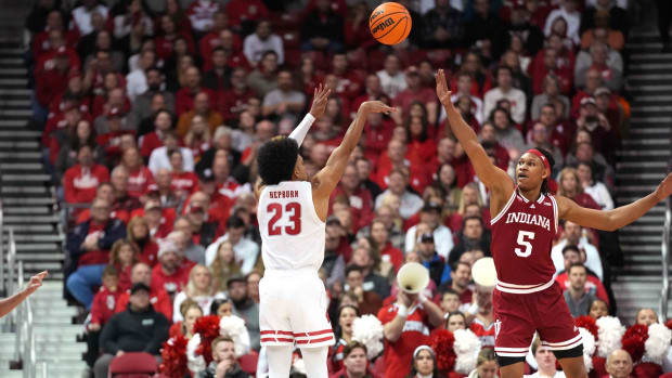 Wisconsin Badgers guard Chucky Hepburn (23) scores a three point basket against Indiana Hoosiers forward Malik Reneau (5) during the first half at the Kohl Center.