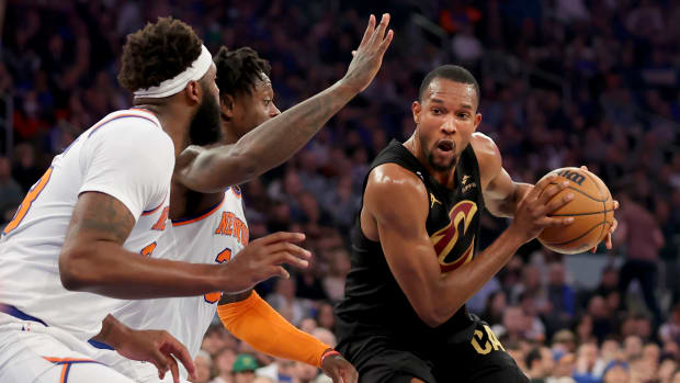 Apr 21, 2023; New York, New York, USA; Cleveland Cavaliers forward Evan Mobley (4) drives to the basket against New York Knicks center Mitchell Robinson (23) and forward Julius Randle (30) during the first quarter of game three of the 2023 NBA playoffs at Madison Square Garden.