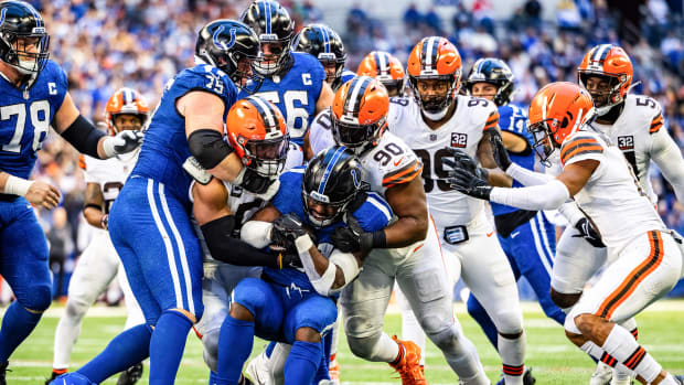 Oct 22, 2023; Indianapolis, Indiana, USA; Indianapolis Colts running back Zack Moss (21) runs the ball while Cleveland Browns defensive end Myles Garrett (95) and defensive tackle Maurice Hurst II (90) defend in the second half at Lucas Oil Stadium. Mandatory Credit: Trevor Ruszkowski-USA TODAY Sports