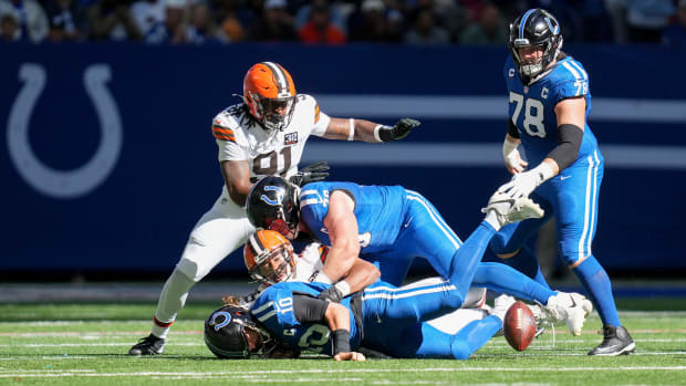 Indianapolis Colts quarterback Gardner Minshew II (10) is sacked by Cleveland Browns tight end David Njoku (85) leading to a fumble Sunday, Oct. 22, 2023, during a game against the Cleveland Browns at Lucas Oil Stadium in Indianapolis.