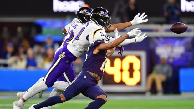 Nov 26, 2023; Inglewood, California, USA; Baltimore Ravens safety Kyle Hamilton (14) and safety Marcus Williams (32) block a pass intended for Los Angeles Chargers wide receiver Jalen Guyton (15) during the first half at SoFi Stadium. Mandatory Credit: Gary A. Vasquez-USA TODAY Sports