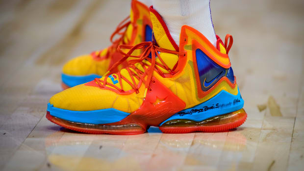 View of yellow, red, and blue Nike LeBron shoes.