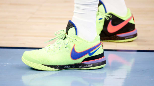 View of LeBron James' green and blue Nike shoes.