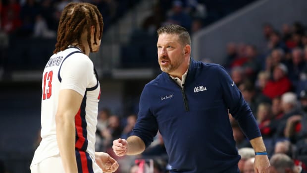 Nov 28, 2023; Oxford, Mississippi, USA; Mississippi Rebels head coach Chris Beard (right) talks with guard Robert Cowherd (13) during the first half against the North Carolina State Wolfpack at The Sandy and John Black Pavilion at Ole Miss. Mandatory Credit: Petre Thomas-USA TODAY Sports