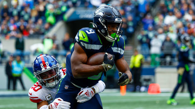 New York Giants safety Julian Love (20) tackles Seattle Seahawks running back Kenneth Walker III (9) on a rushing attempt during the first quarter at Lumen Field.