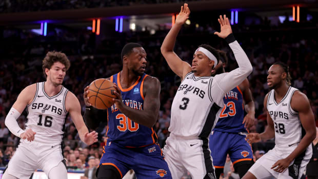 New York Knicks forward Julius Randle (30) controls the ball against San Antonio Spurs forwards Cedi Osman (16) and Keldon Johnson (3) and center Charles Bassey (28) during the third quarter at Madison Square Garden.
