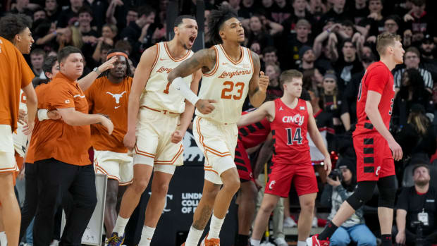 Texas Longhorns forward Dylan Disu (1) and forward Dillon Mitchell (23) celebrate defeating the Cincinnati Bearcats at Fifth Third Arena.