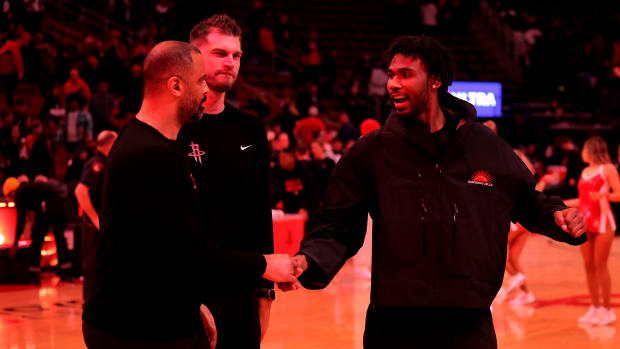 Rockets head coach Ime Udoka and Houston Rockets forward Tari Eason (17) leave the court following the game against the Brooklyn Nets at Toyota Center.