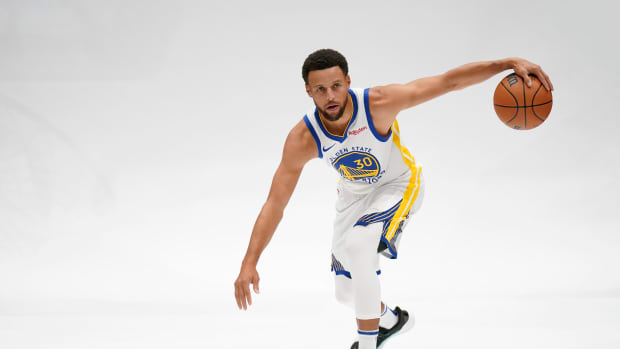 Golden State Warriors guard Stephen Curry dribbles the ball during a photo shoot.