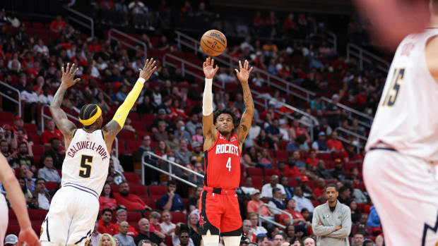 Rockets guard Jalen Green shoots the ball as Denver Nuggets guard Kentavious Caldwell-Pope defends during the second quarter at Toyota Center.