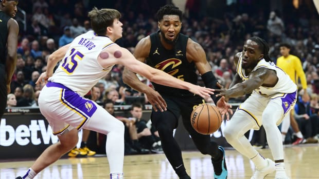 Nov 25, 2023; Cleveland, Ohio, USA; Cleveland Cavaliers guard Donovan Mitchell (45) drives to the basket between Los Angeles Lakers guard Austin Reaves (15) and forward Taurean Prince (12) during the first half at Rocket Mortgage FieldHouse. Mandatory Credit: Ken Blaze-USA TODAY Sports  