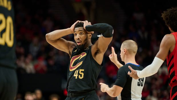 Nov 15, 2023; Portland, Oregon, USA; Cleveland Cavaliers guard Donovan Mitchell (45) reacts to a three point play by teammate guard Max Strus (1) during the second half against the Portland Trail Blazers at Moda Center. Mandatory Credit: Troy Wayrynen-USA TODAY Sports