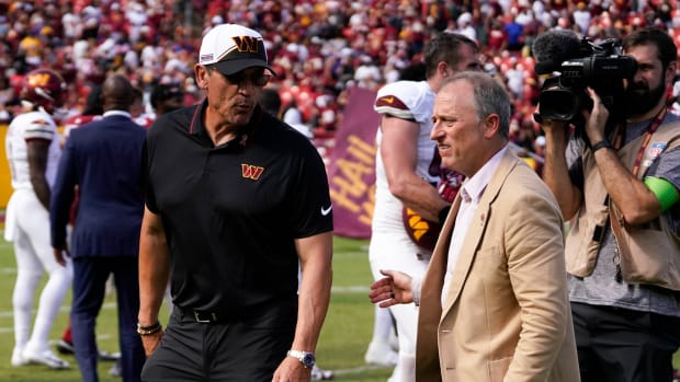 Washington Commanders head coach walks with Washington Commanders managing partner Josh Harris following the Commanders victory over the Arizona Cardinals at FedExField.