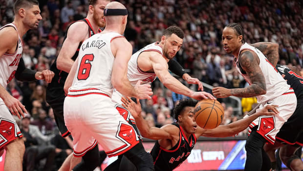 Apr 12, 2023; Toronto, Ontario, CAN; Chicago Bulls guard Zach LaVine (8) knocks the ball away from Toronto Raptors forward Scottie Barnes (4) as Chicago Bulls forward DeMar DeRozan (11) looks on during the second half of a NBA Play-In game at Scotiabank Arena.